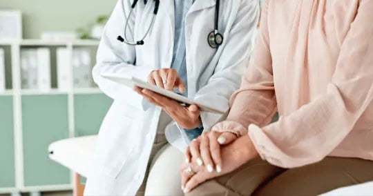 Clinician with a tablet consulting a patient